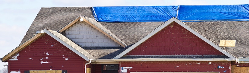 Emergency tarp on a storm-damaged roof in Elk River, MN, installed by Kiser Construction