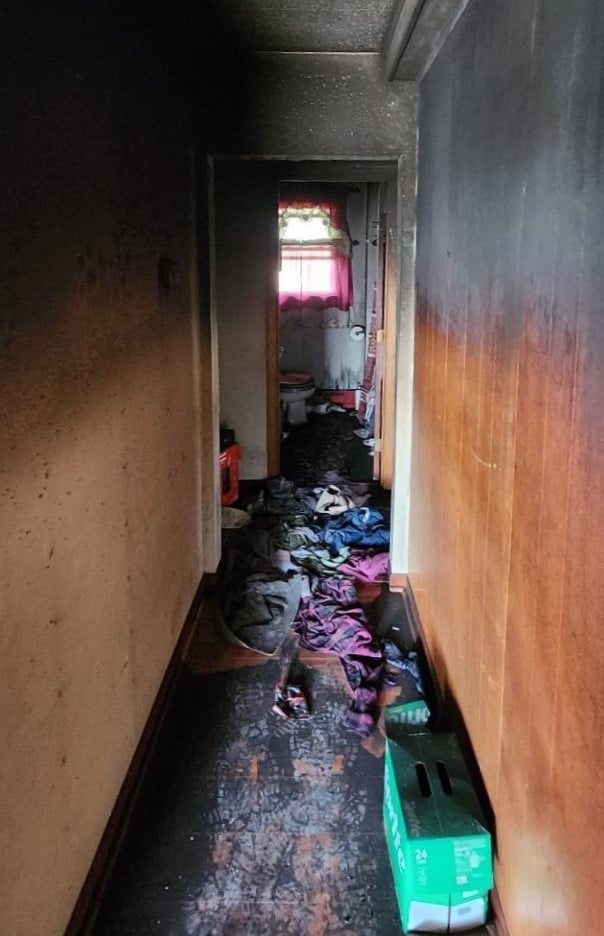 Soot-blackened hallway walls before smoke damage cleanup by Kiser Construction in Minnesota